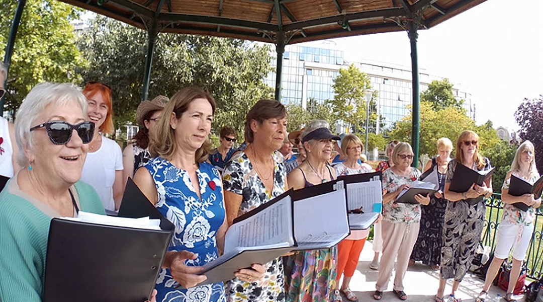 A choir tour group perform in a bandstand in Paris