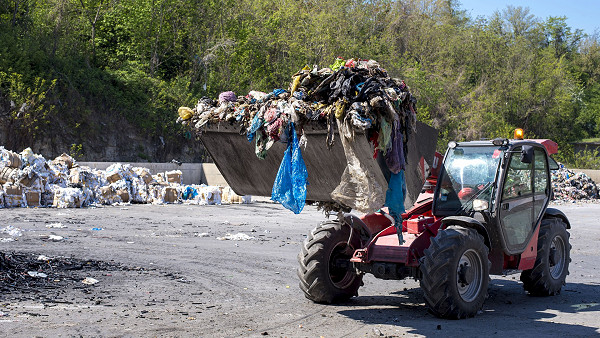 clothes being dumped at a landfill site