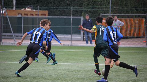 Boys play a match as part of a football stadium tour to Atalanta