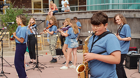 Performing in the band on their school music trip